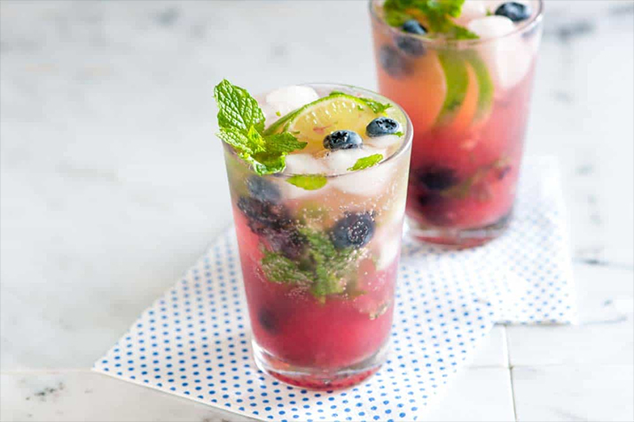 Blueberry Strawberry Mojito - Refreshing mojitos made with blueberries, strawberries, and mint.