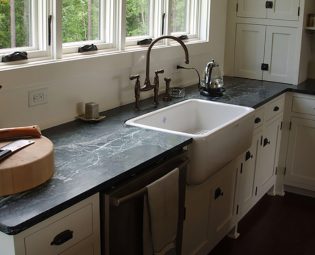 Dark soapstone counters, white farmhouse sink