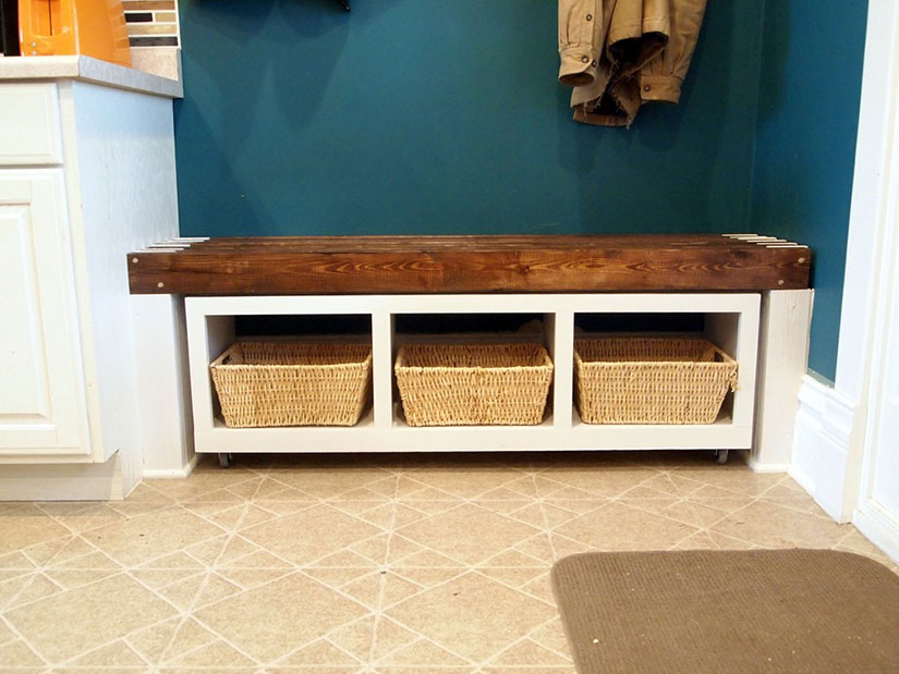Mudroom bench with three cubbies and baskets.