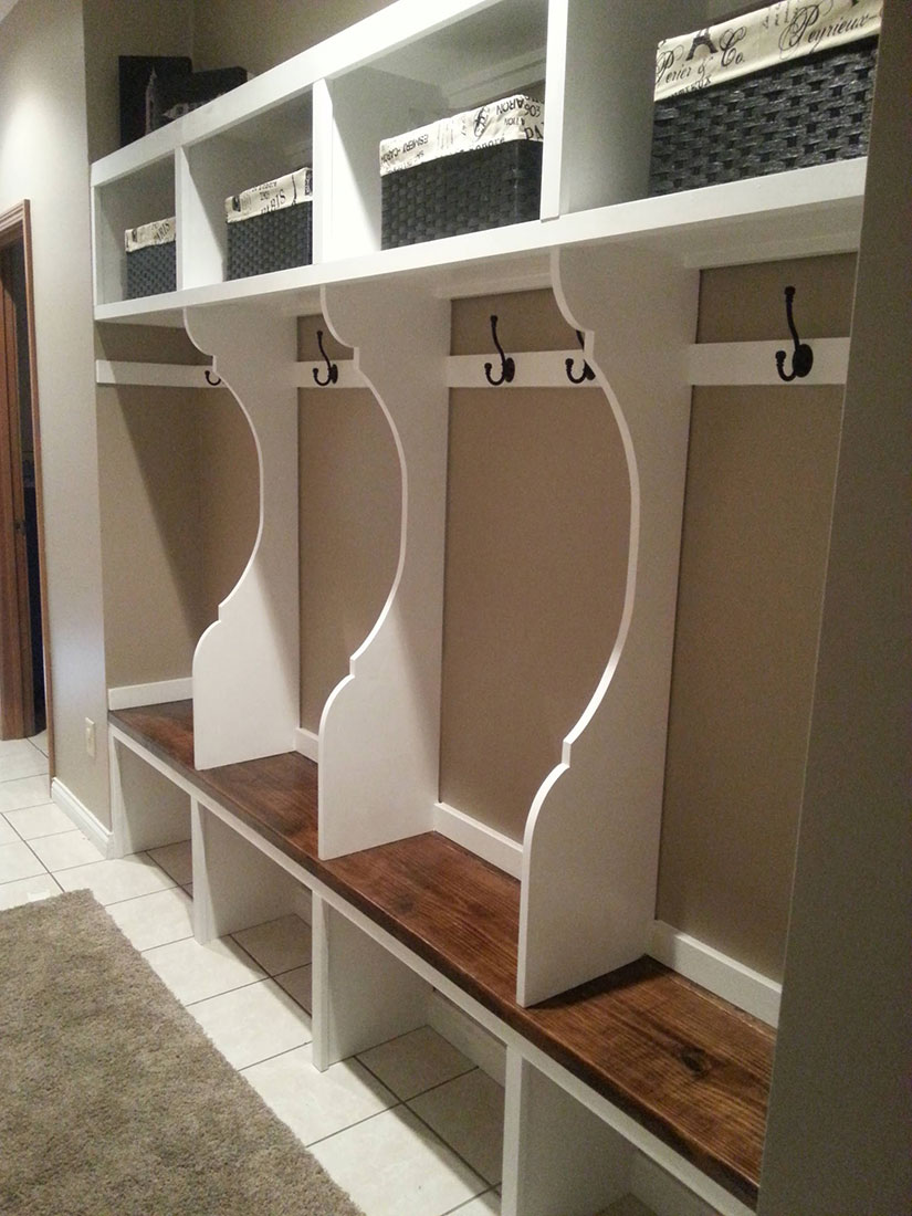 Mudroom lockers include multiple cubbies, coat hooks, and shelves.