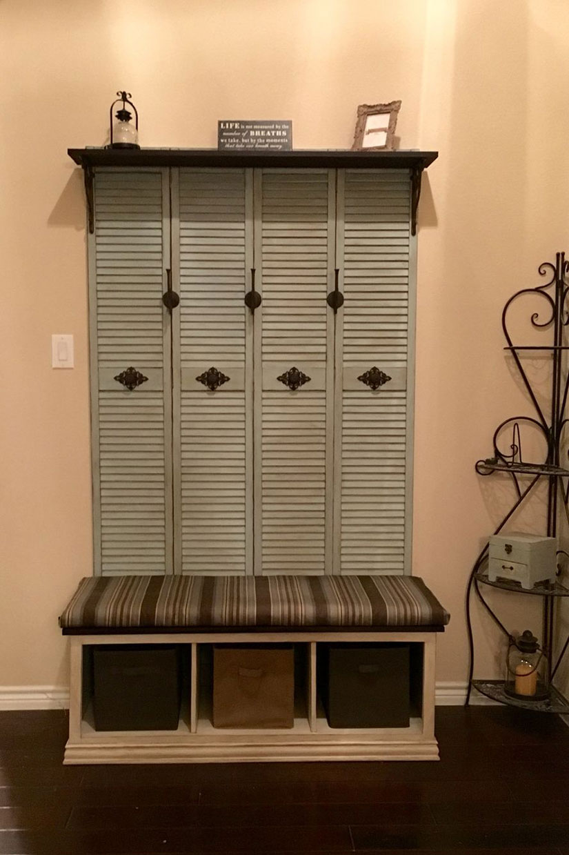 This mudroom uses recycled old closet shutter doors and includes a shelf, coat hangers, and a bench.