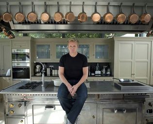 Gordon Ramsay sitting on his Rorgue cooker, the centerpiece of his five-star home kitchen