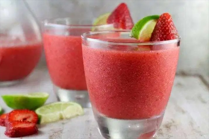 Non Alcoholic Strawberry Daquiri - Strawberry daiquiris garnished with strawberries and lime.