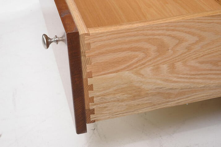 Wooden drawer with half-blind dovetail joints exposed.