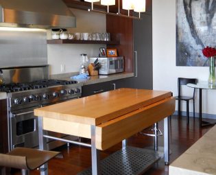 Wood kitchen island prep table in modern kitchen