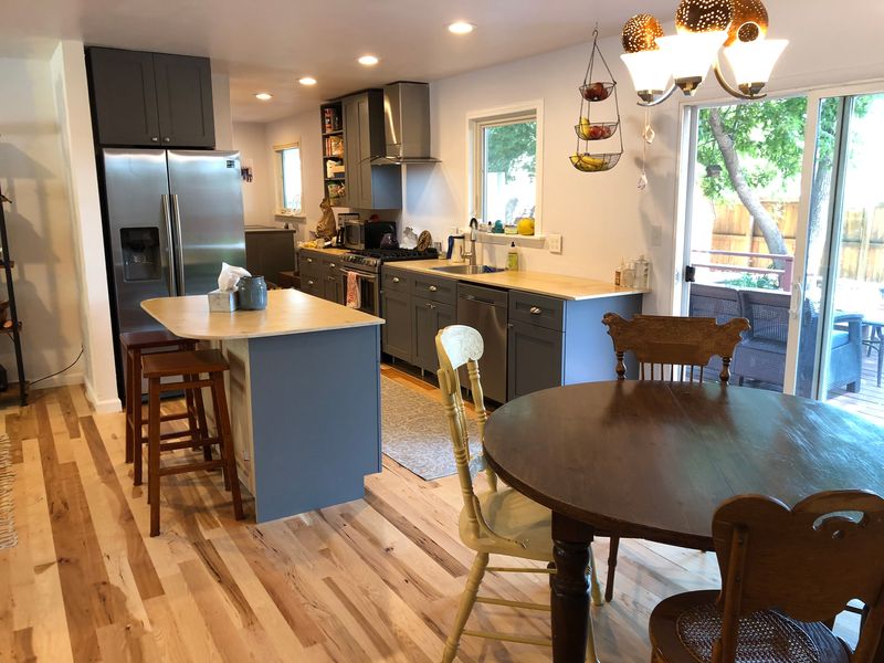 A customer's kitchen with Storm Gray cabinets and a breakfast table