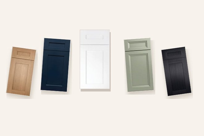 Five cabinet door samples fanned out in oak, navy, white, sage and black