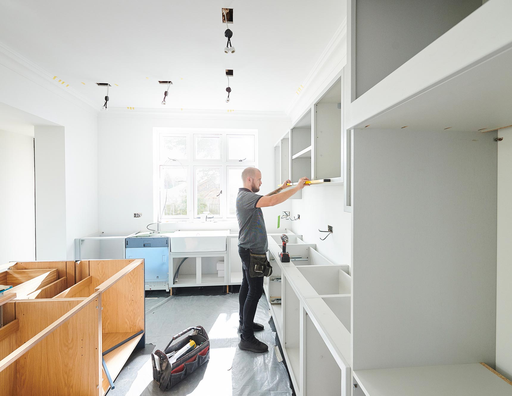 Man mounting cabinet