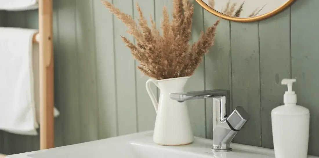 Sage green paneled bathroom